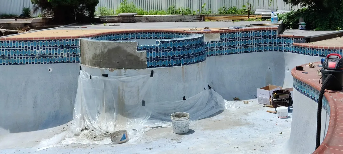 Pool spa under renovation with new tile band and replaster prep