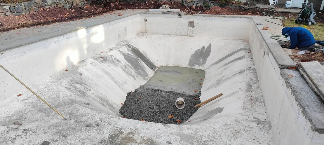 Empty pool with fresh concrete and gravel during renovation